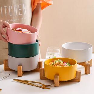 A wooden racked salad bowl with the keys to a pet racked cat