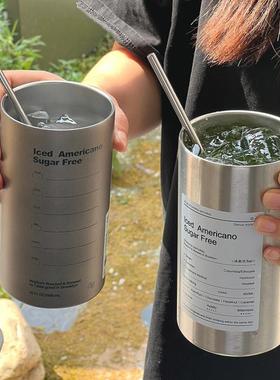 A large double-storey stainless steel cup with a capricious