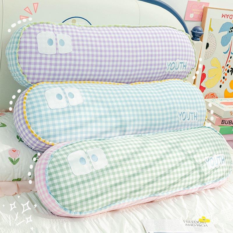 A minimalist dopamine-colored long pillow, featuring cartoon