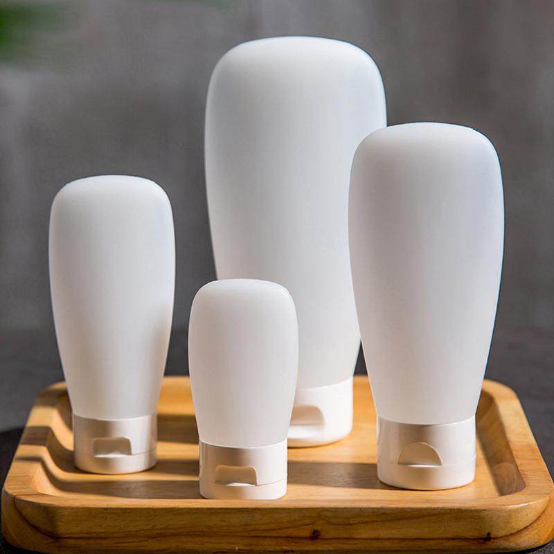 Travel-sized empty cosmetic bottles, including shampoo and b