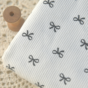 米白底黑色蝴蝶结涤纶灯芯绒  秋冬连衣裙子上衣外套裤子马甲面料