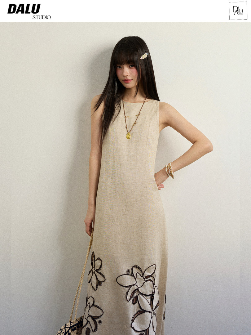 Model wearing a sleeveless beige floral dress