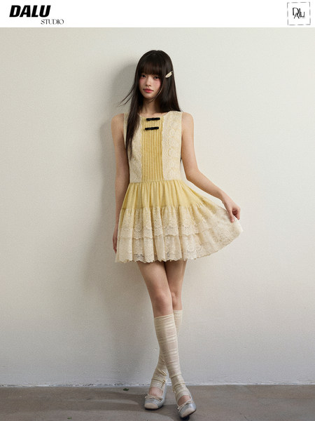Model wearing a light yellow sleeveless lace dress