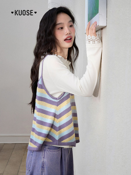 Model wearing a striped knit camisole over a white long-sleeve top