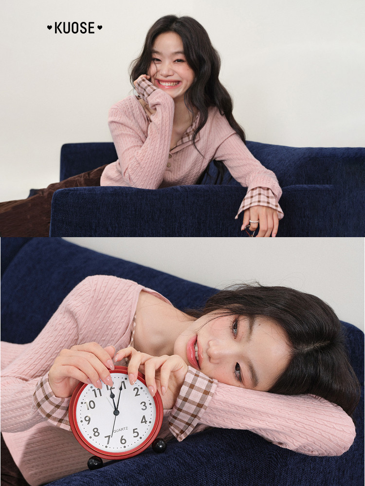 Pink knit sweater worn by a smiling model on a couch