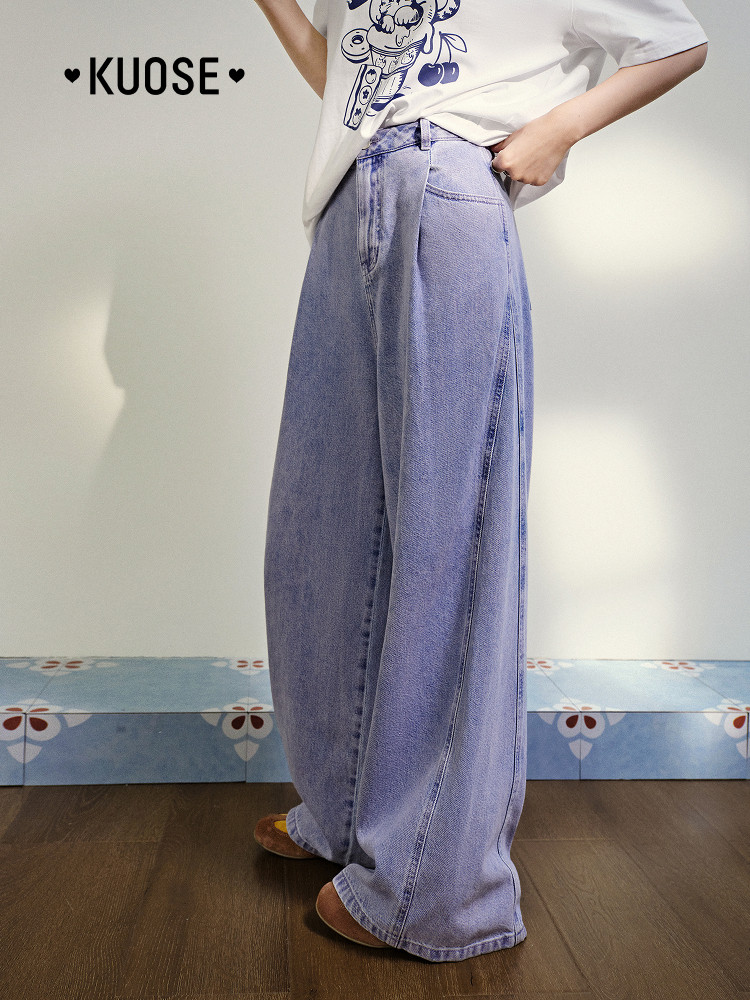 Model wearing light blue wide-leg denim jeans