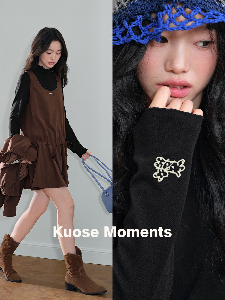 Model wearing a brown layered mini dress with black top and brown boots