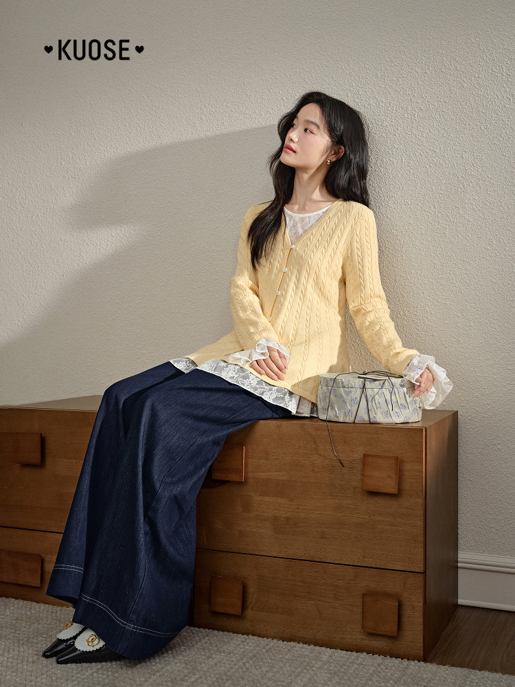 Model wearing a pale yellow knit cardigan with layered lace trim and dark wide-leg jeans