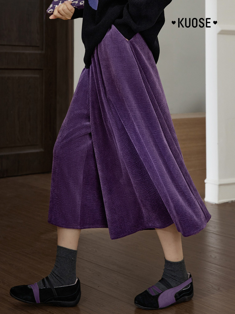 Purple midi skirt worn by a model with black shoes