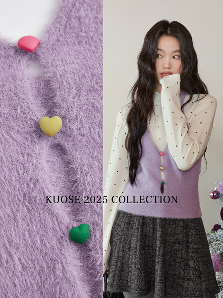 Model wearing a lavender fuzzy knit vest over a sheer polka dot blouse