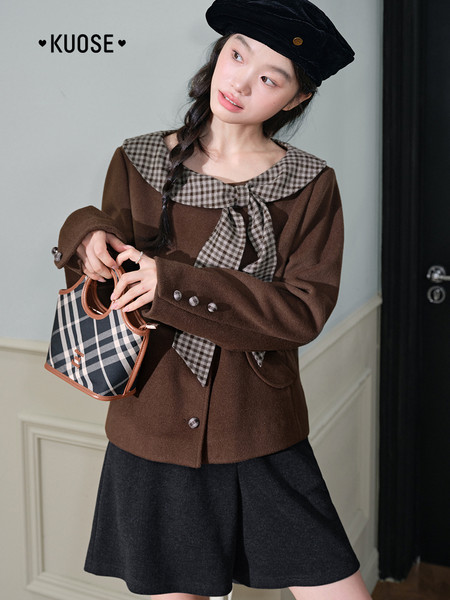 Model wearing a brown sailor-collar jacket with a matching handbag and black bottoms