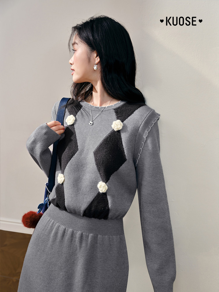Model wearing a gray knit sweater and matching skirt set