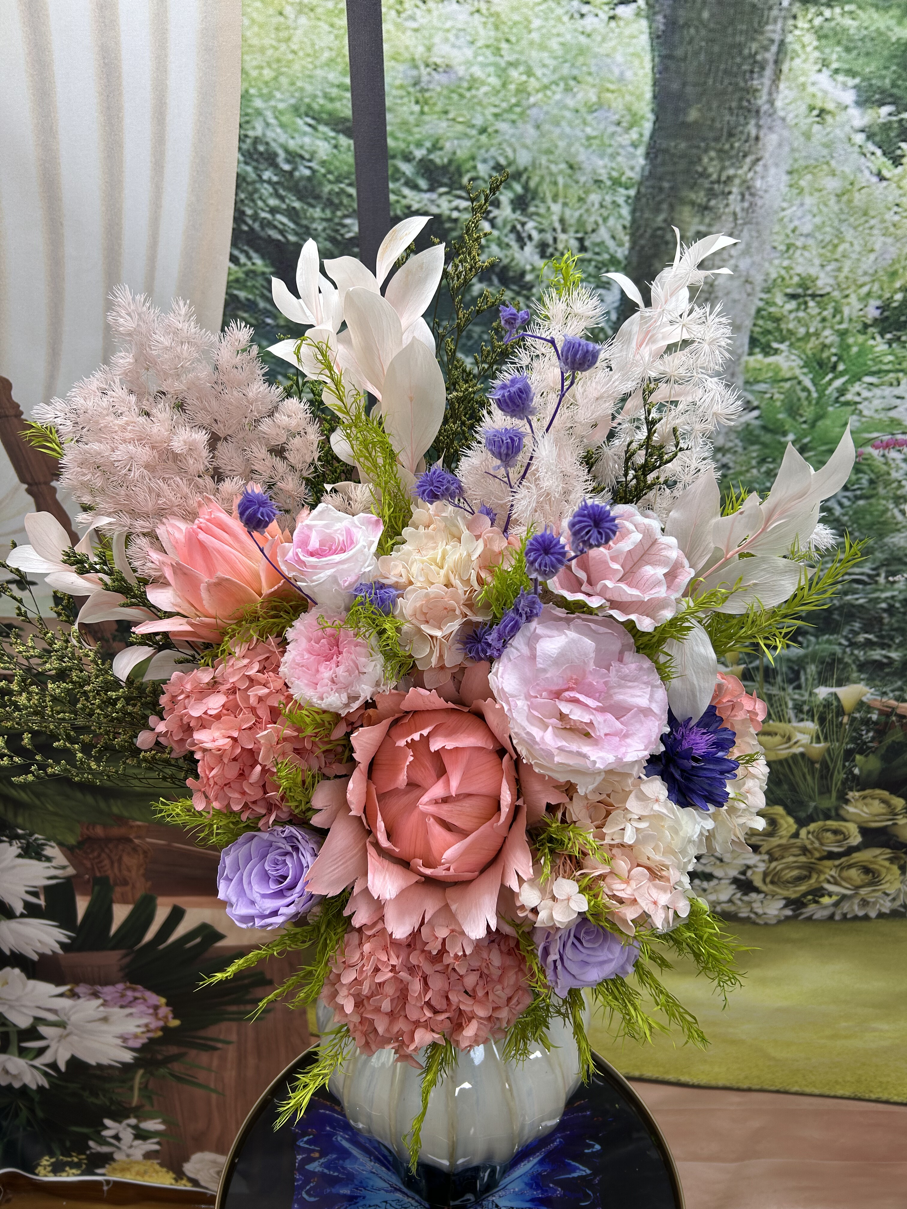 永生的山茶花、法国百合、洋桔梗、玫瑰、桔叶、年轮果等组合桌花