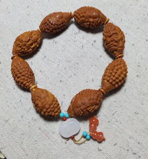 橄榄核一念之间16*27MM手串配南红和田玉