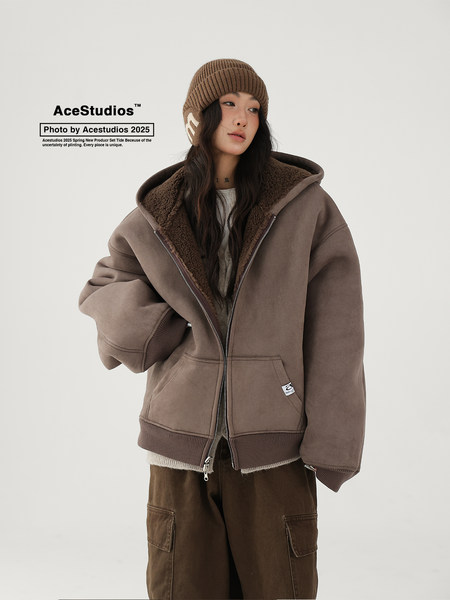 Model wearing a brown oversized hooded fleece jacket and knit beanie