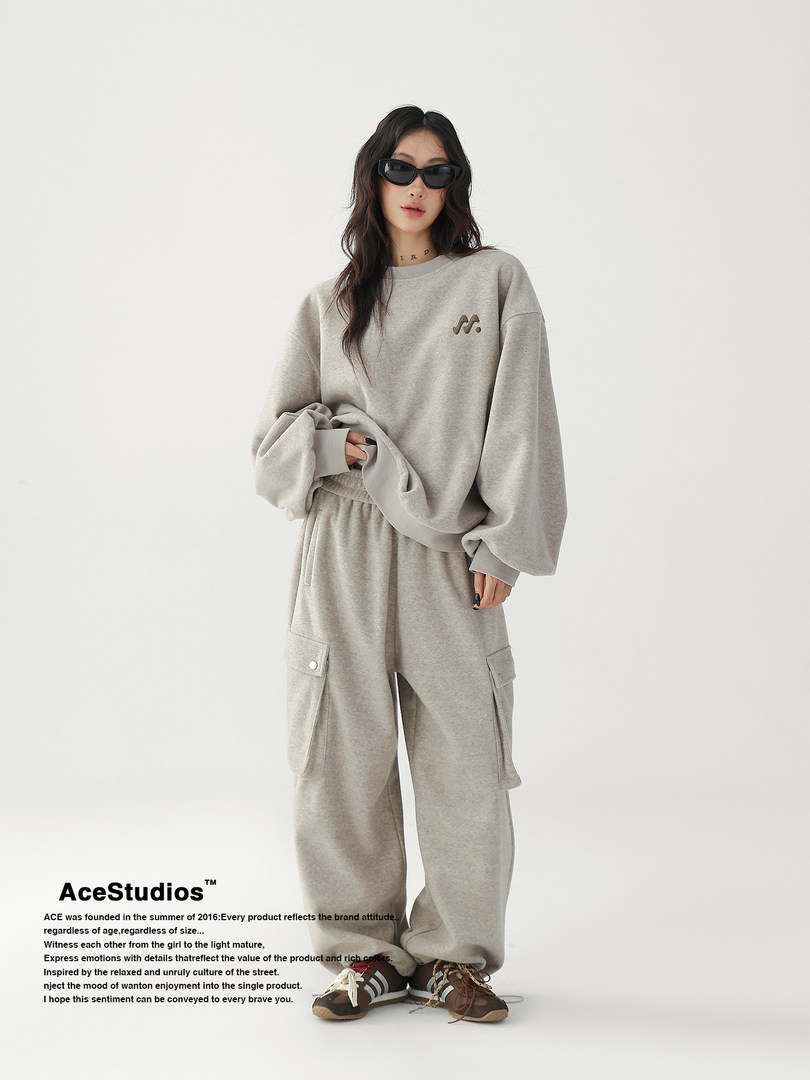 Model wearing a gray oversized sweatshirt and matching cargo sweatpants