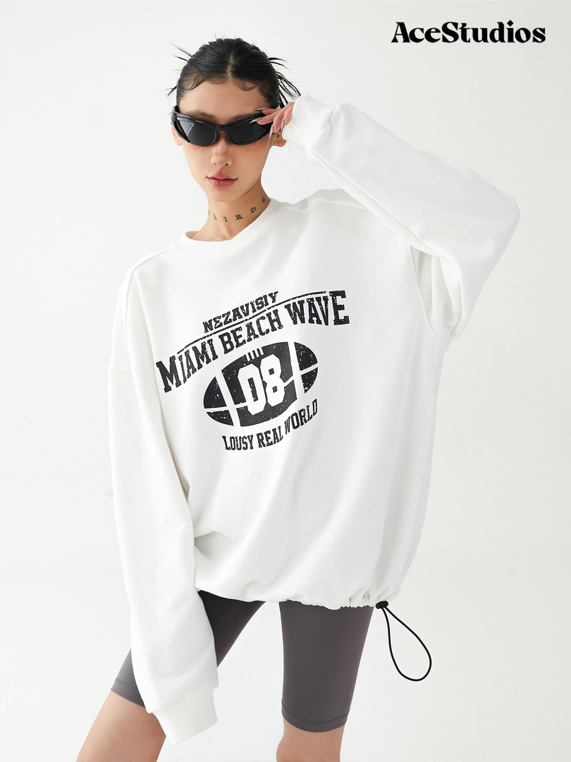 Model wearing an oversized white graphic sweatshirt with black print