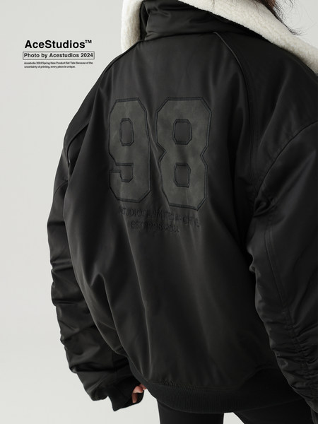 Black oversized jacket worn by a model, shown from the back