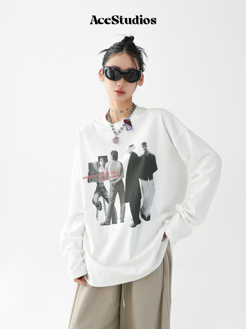 Model wearing a white graphic long-sleeve sweatshirt with oversized fit