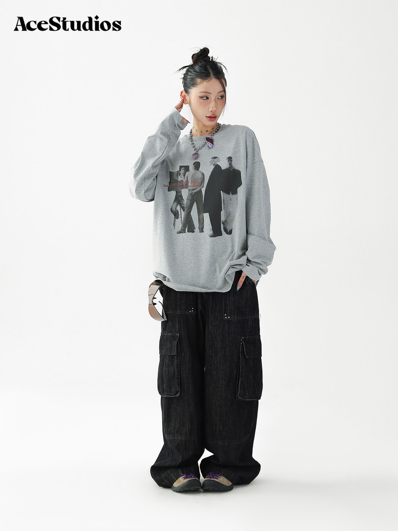 Model wearing a gray graphic oversized sweatshirt with black cargo pants