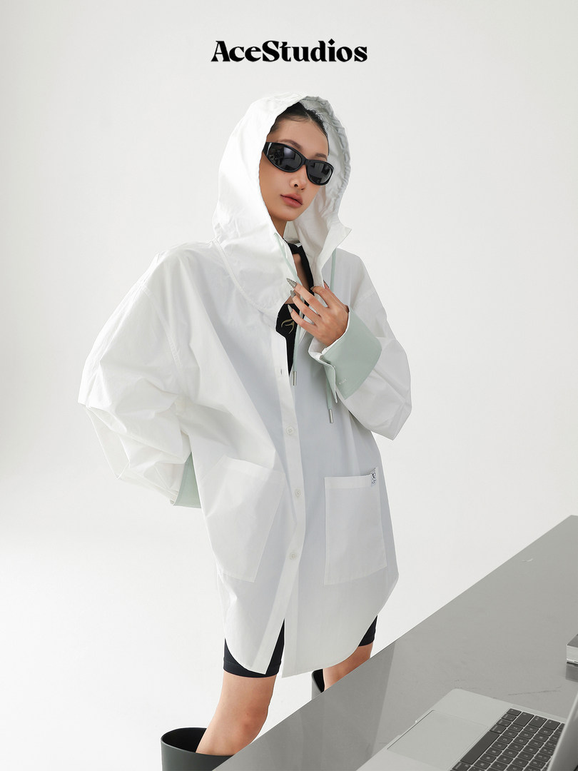Model wearing a white hooded oversized shirt jacket