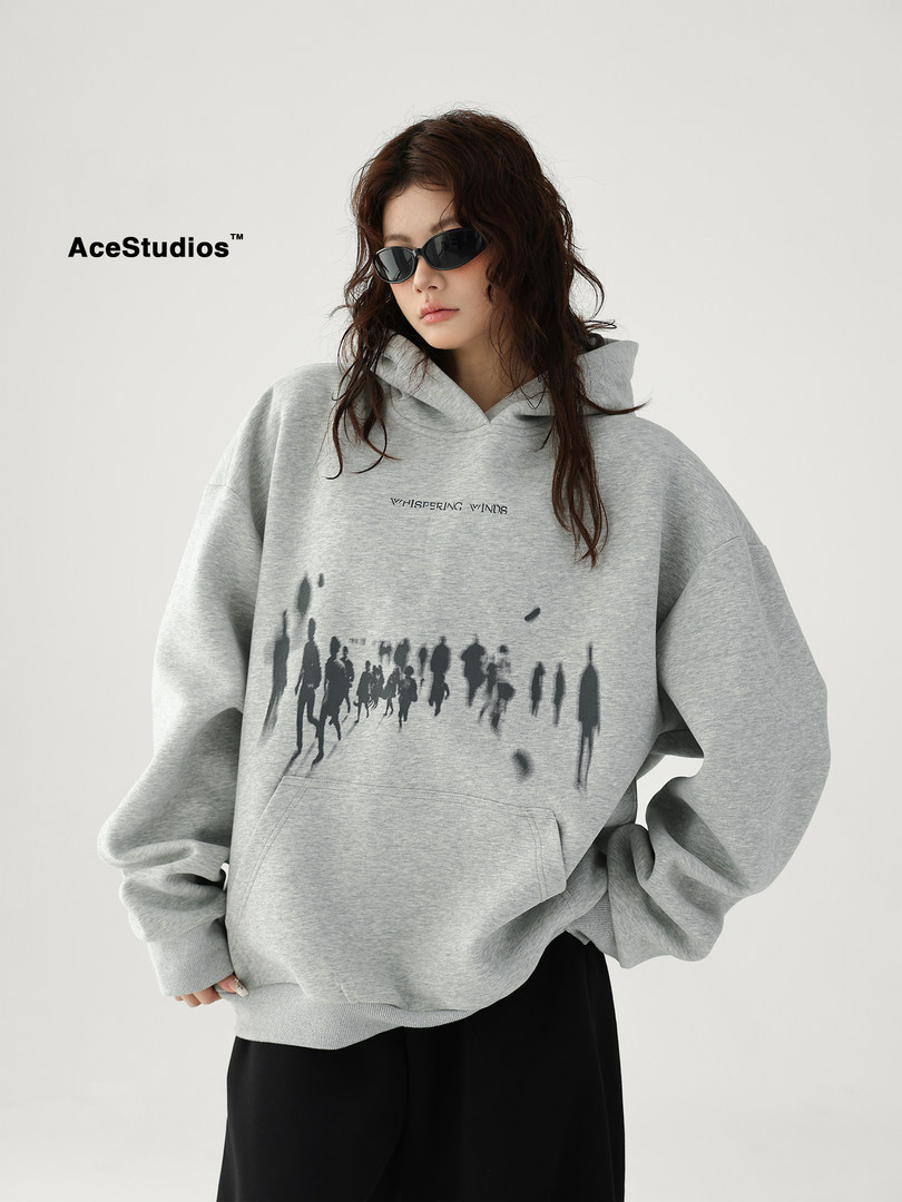 Model wearing a gray oversized graphic hoodie