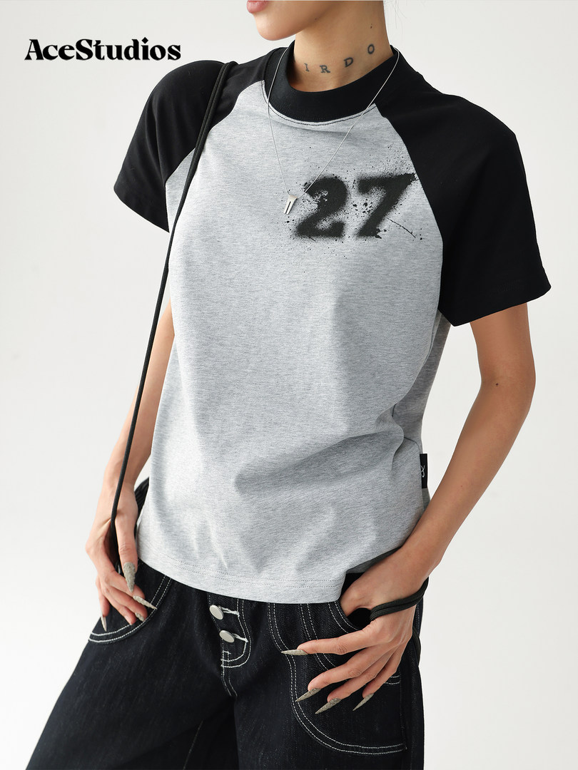 Model wearing a black and gray graphic raglan T-shirt with a large "27" print