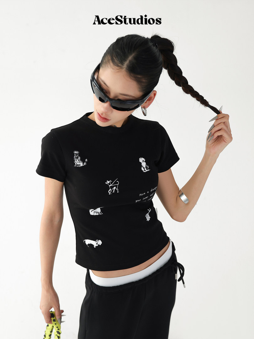 Black graphic crop top worn by a model with a fitted casual streetwear look