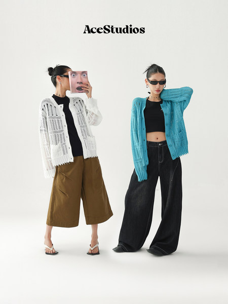 Two models wearing open-knit button cardigans in white and blue styled with wide-leg pants