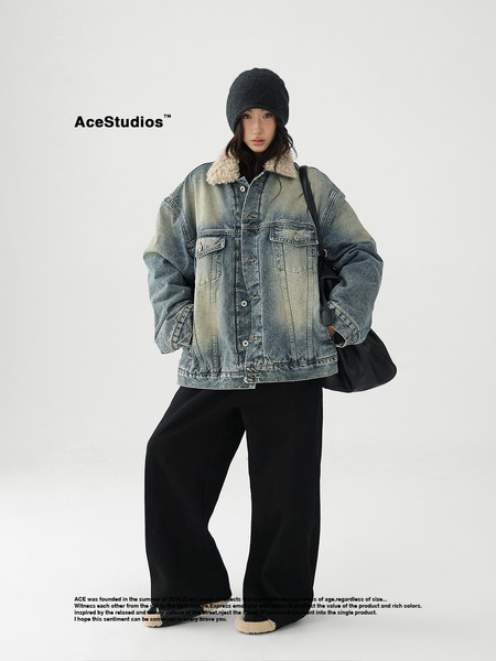 Model wearing an oversized denim shearling jacket with black wide-leg pants