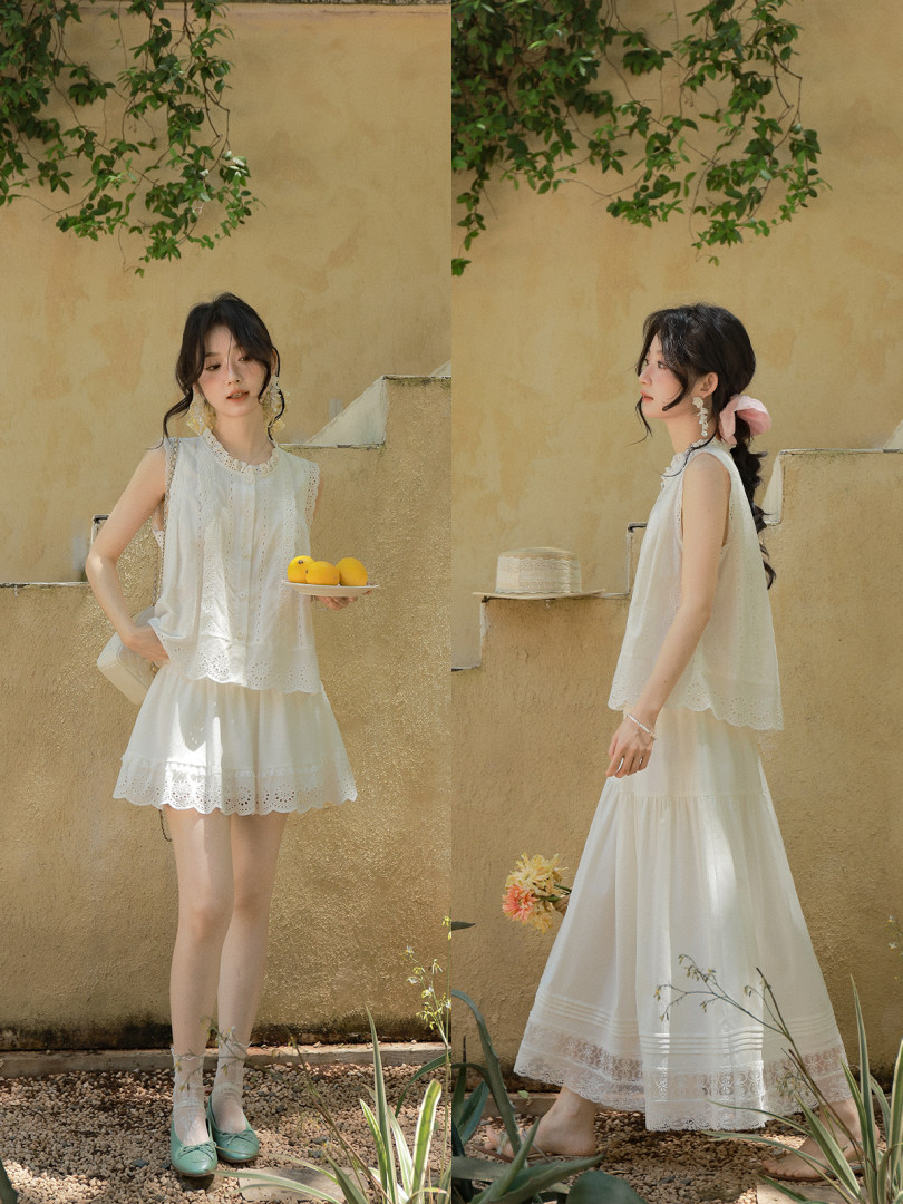 White sleeveless eyelet top and matching long skirt worn by a model outdoors