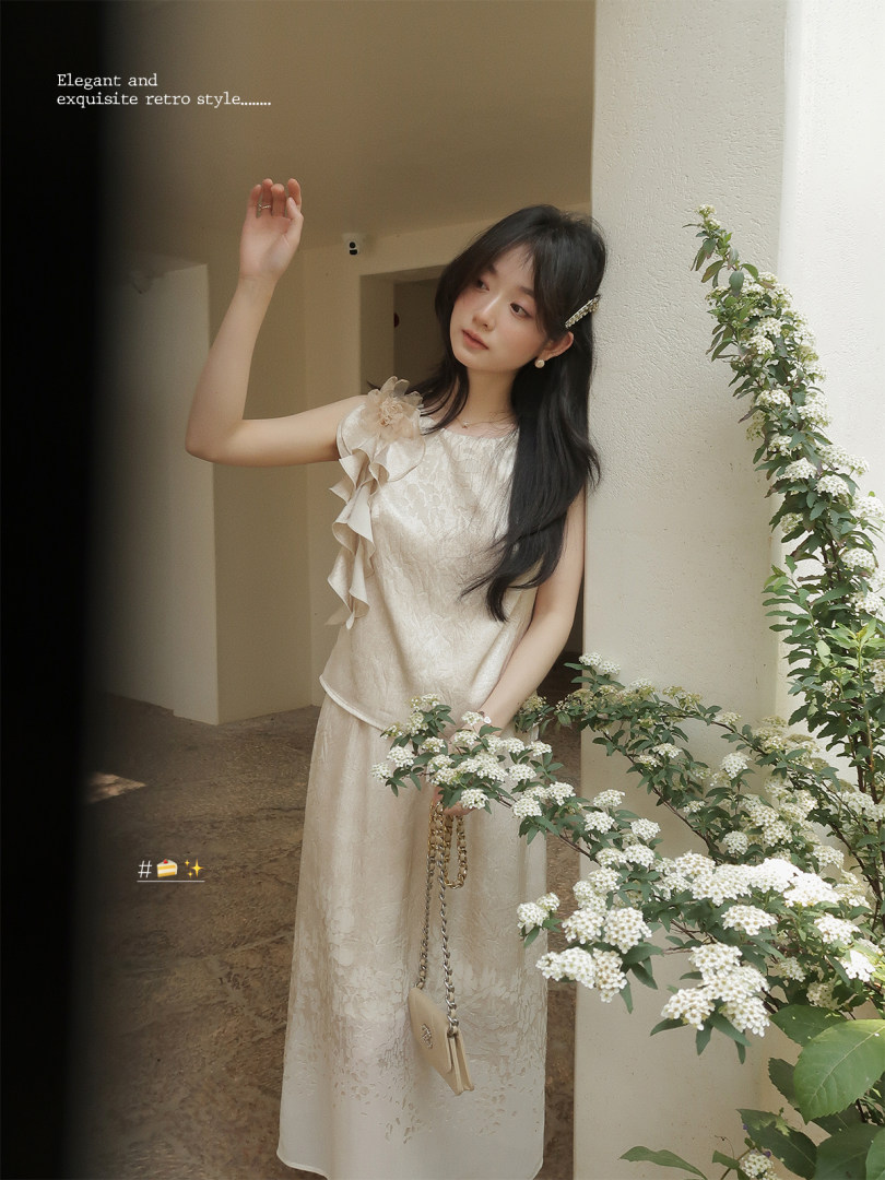 Woman wearing a light beige sleeveless lace dress with ruffle detail