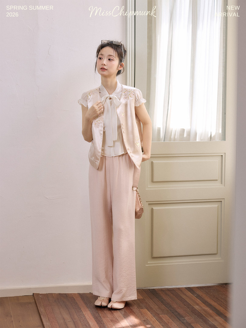 Pastel pink sleeveless top and wide-leg pants outfit worn by a model