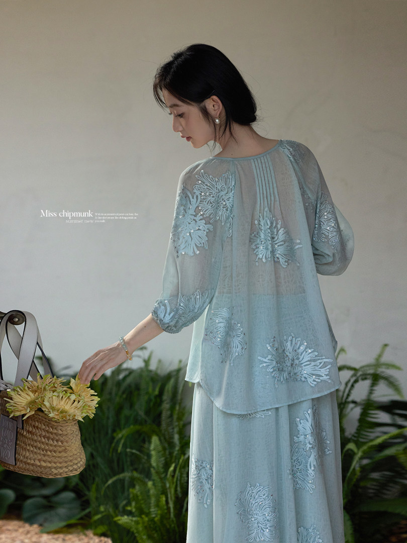 Light blue sheer embroidered outfit worn by a model