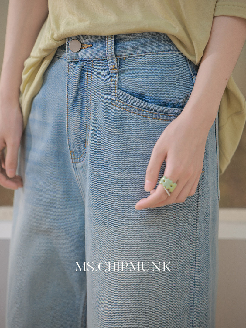 Light blue high-waisted wide-leg jeans worn by a model
