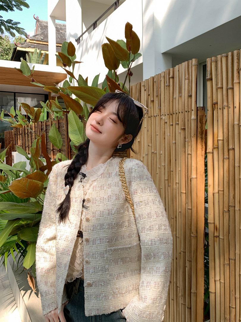 Light pastel tweed cardigan worn by a model outdoors