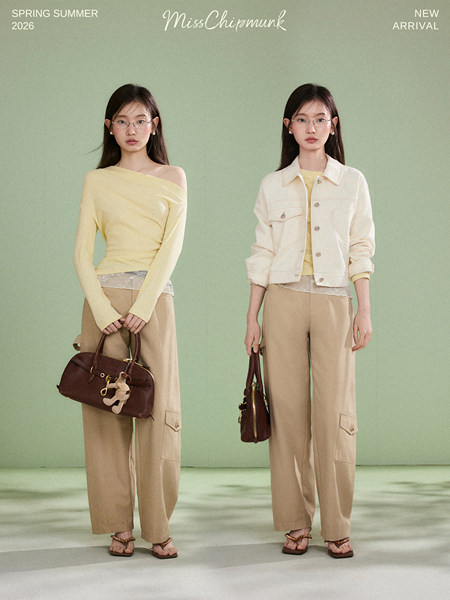 Two models wearing pastel spring-summer outfits with handbags on a studio background