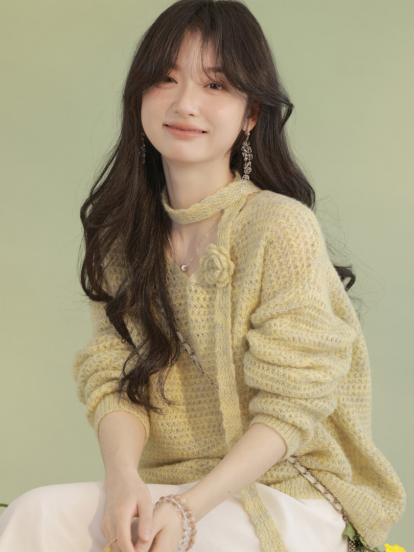 Model wearing a light yellow fuzzy knit sweater