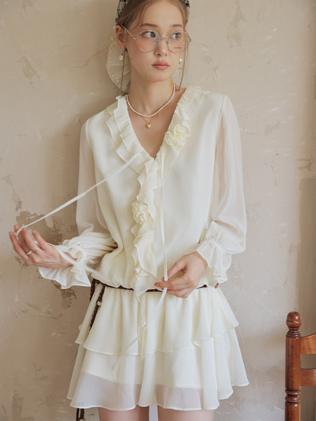 White ruffled long-sleeve dress worn by a model