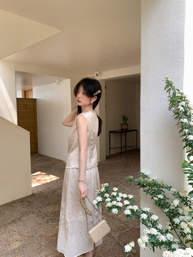 Beige sleeveless satin two-piece outfit worn by a model