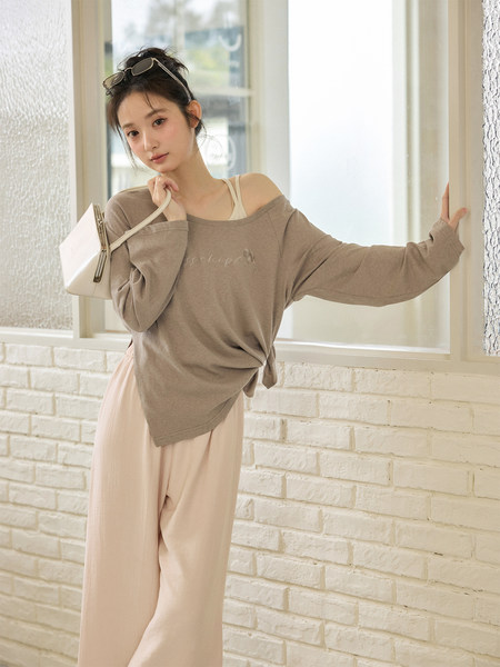 Woman modeling a casual off-shoulder lounge outfit with loose pants