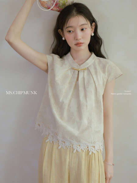 Light cream sleeveless blouse worn by a model
