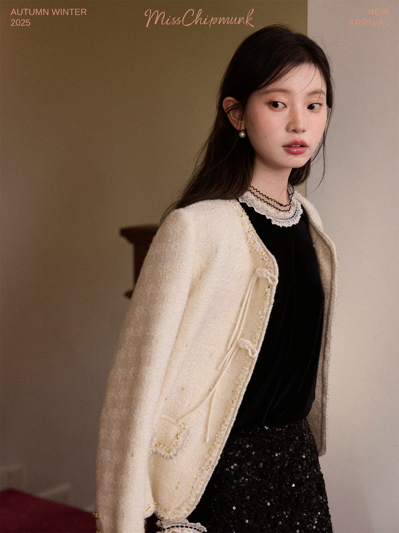 Model wearing a cream textured cardigan jacket over a black outfit