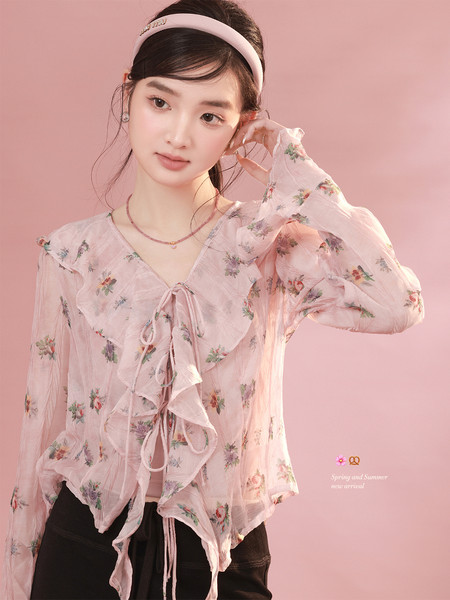 Pink floral sheer blouse worn by a model