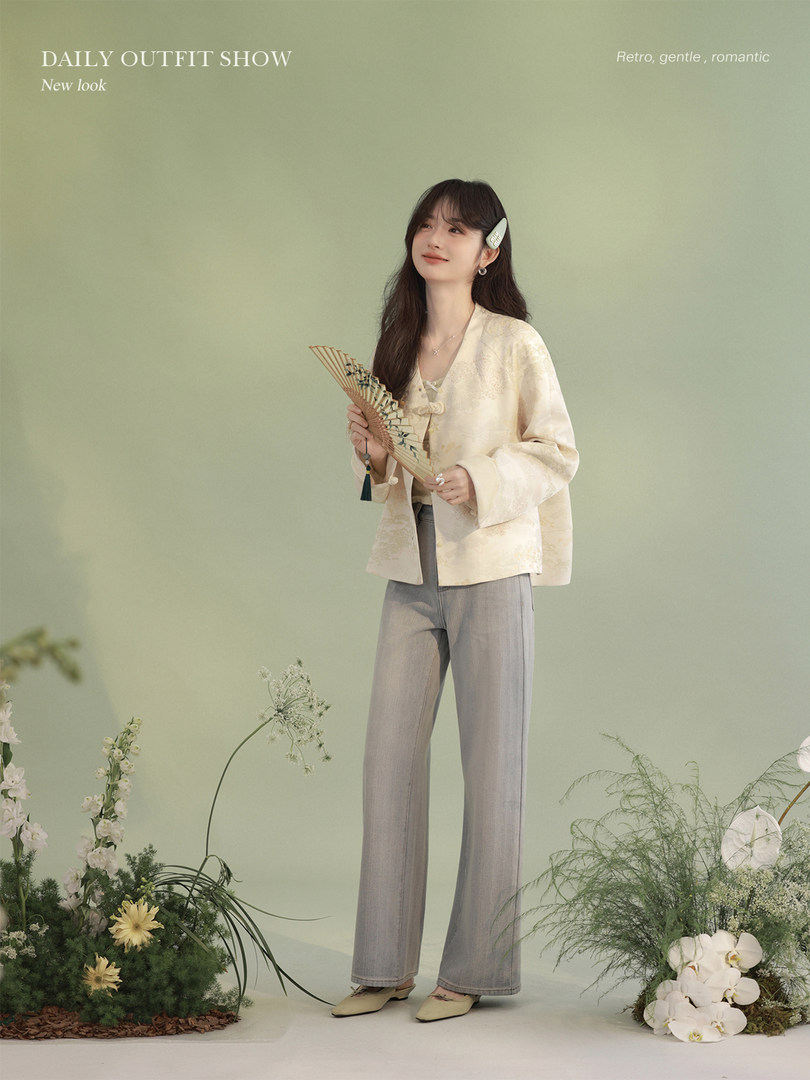 Model wearing a light cream top with wide-leg gray pants in a styled studio outfit shoot