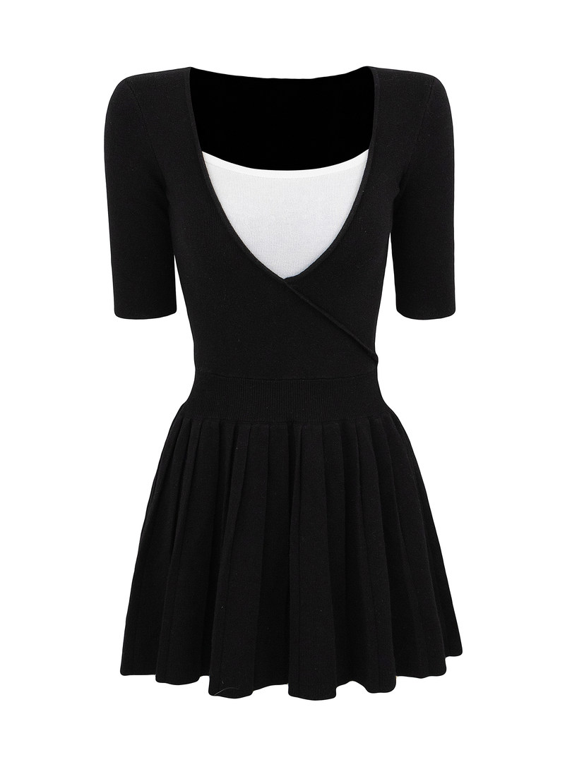 Black knitted dress with white inner layer and pleated skirt
