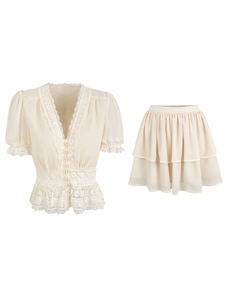 Cream-colored lace-trimmed blouse and tiered skirt set displayed on white background