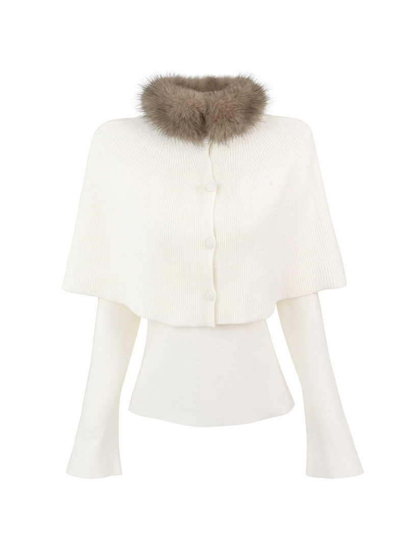 Cream knit cape with faux fur collar displayed on mannequin