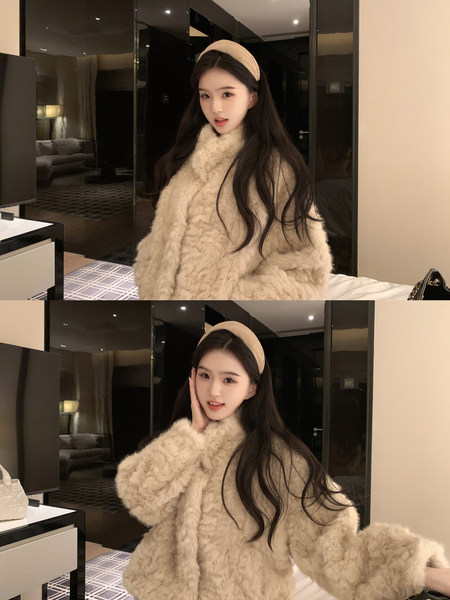 Woman wearing a beige fluffy coat and headband in a hotel room setting