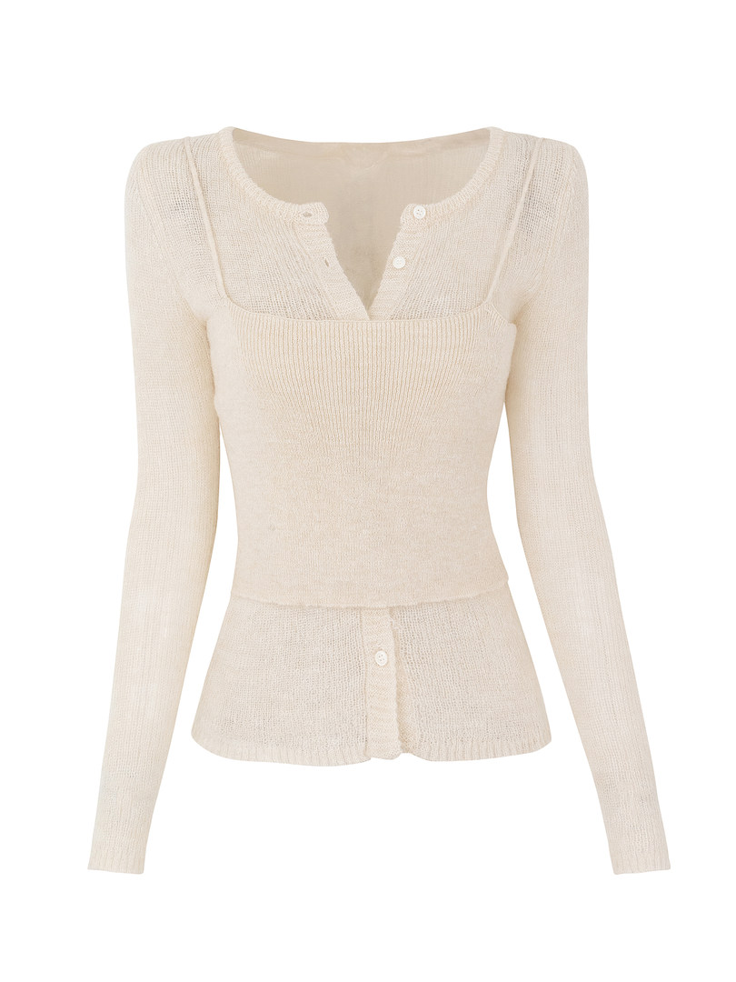 Cream-colored long-sleeve knit top with button details and peplum hem
